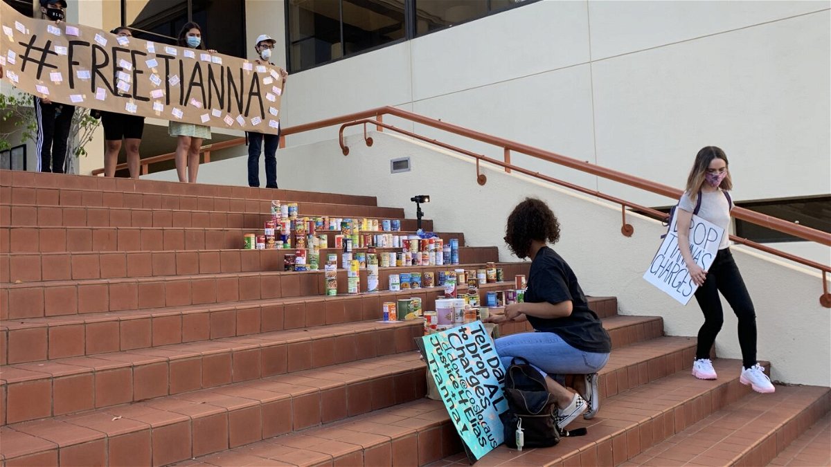 Protesters bring cans of food to donate at a Free Tianna Arata protest in San Luis Obispo.