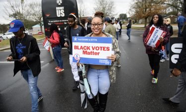 Fayetteville State University students get off a Black Votes Matter bus at Smith Recreation Center on March 3