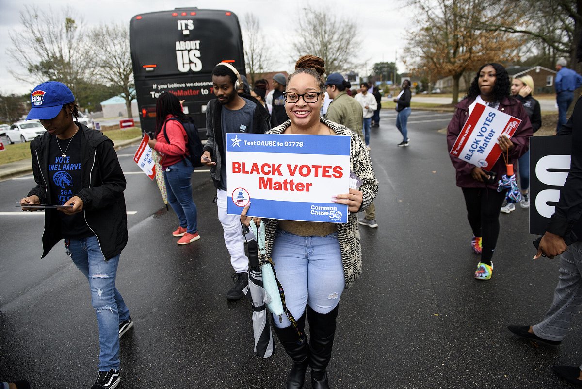 <i>Melissa Sue Gerrits/Getty Images</i><br/>Fayetteville State University students get off a Black Votes Matter bus at Smith Recreation Center on March 3