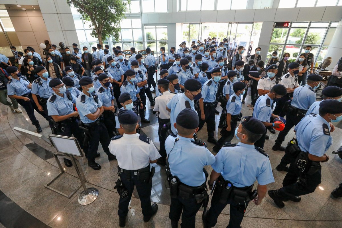 <i>Apple Daily/Getty Images</i><br/>Police officers raid the Apple Daily office on June 17 in Hong Kong.