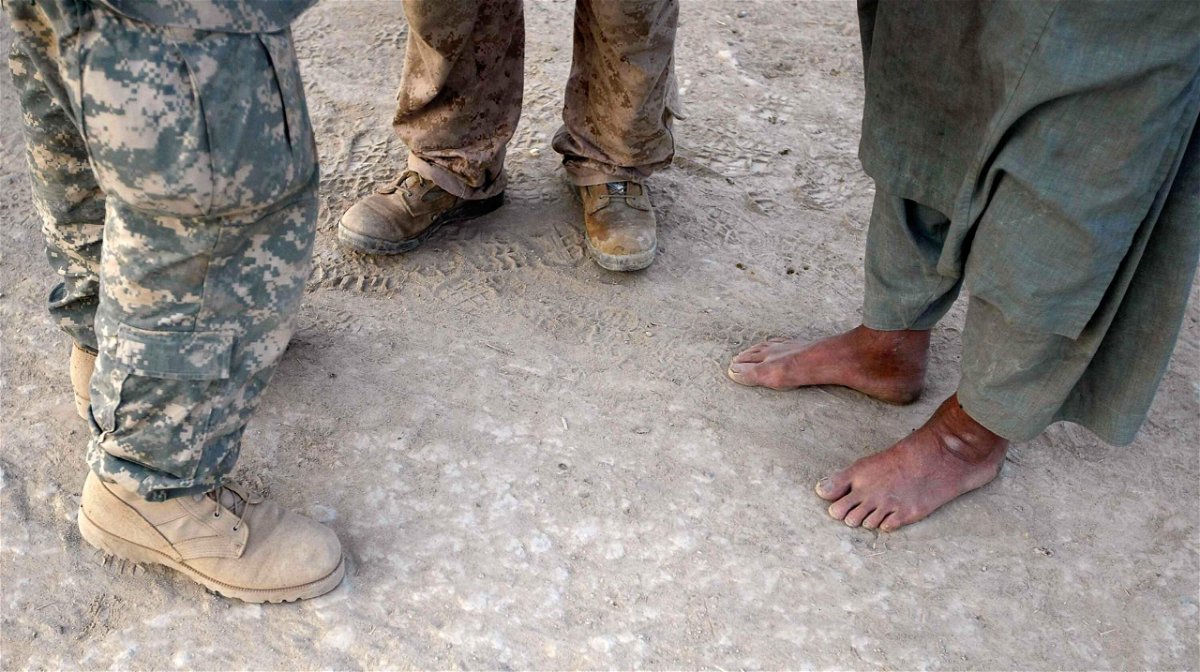 <i>Joe Raedle/Getty Images</i><br/>A U.S. Marine (C) talks through his interpreter (L) to an Afghan man during a patrol on July 6