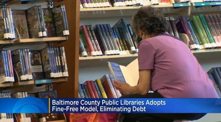 <i>WJZ</i><br/>A woman browses for books at a library in the Baltimore County system. The system has adopted a fine-free model and eliminated outstanding balances.