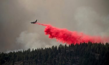 An air tanker drops retardant to keep the Sugar Fire from reaching the Beckwourth community of unincorporated Plumas County
