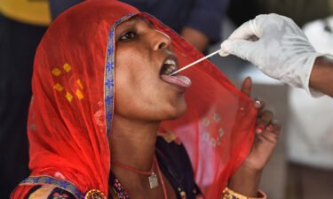 A health worker collects a swab sample for a Covid-19 test in Mumbai