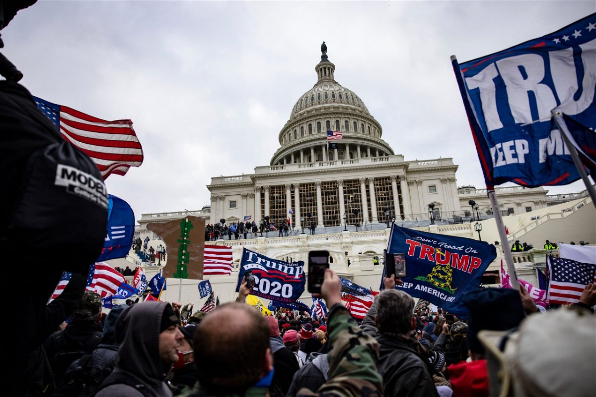<i>Samuel Corum/Getty Images</i><br/>Pro-Trump supporters storm the U.S. Capitol following a rally with President Donald Trump on January 6. A third member of the far-right Oath Keepers group will plead guilty on July 20 and cooperate with prosecutors