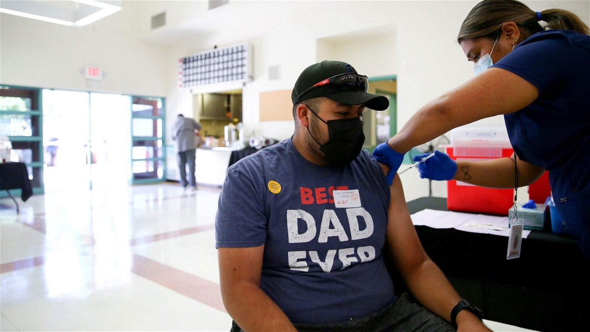 <i>Mario Tama/Getty Images</i><br/>Leslie Garcia administers a Covid-19 vaccination dose to Raul Zarate at a clinic in South Los Angeles on June 25 in Los Angeles