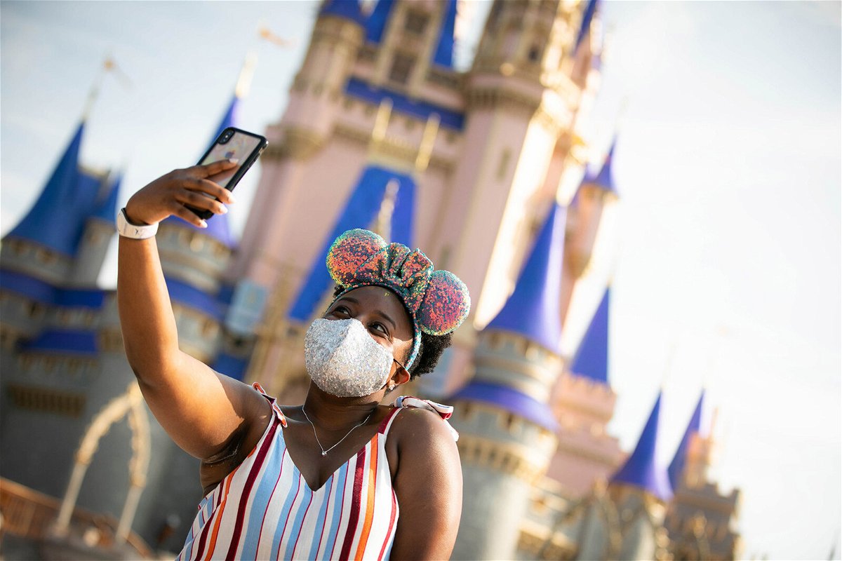 <i>Walt Disney World Resort/Getty Images</i><br/>A guest stops to take a selfie at Magic Kingdom Park at Walt Disney World Resort on July 11