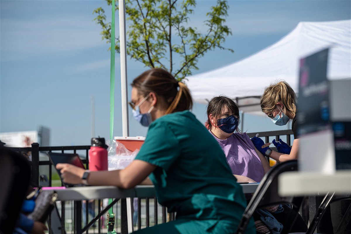 <i>Jon Cherry/Getty Images</i><br/>A nurse administers a shot of COVID-19 vaccine during a pop-up vaccination event at Lynn Family Stadium on April 26 in Louisville