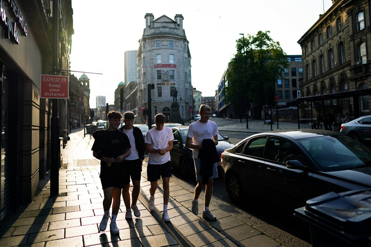 <i>Ian Forsyth/Getty Images</i><br/>Friends walk along a street in Newcastle on July 19 the day England dropped almost all Covid-19 restrictions.