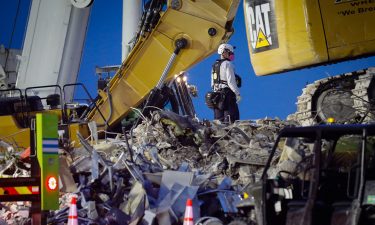 Search and rescue teams continue to work in the rubble at the site of the collapsed Champlain Towers South condo in Surfside