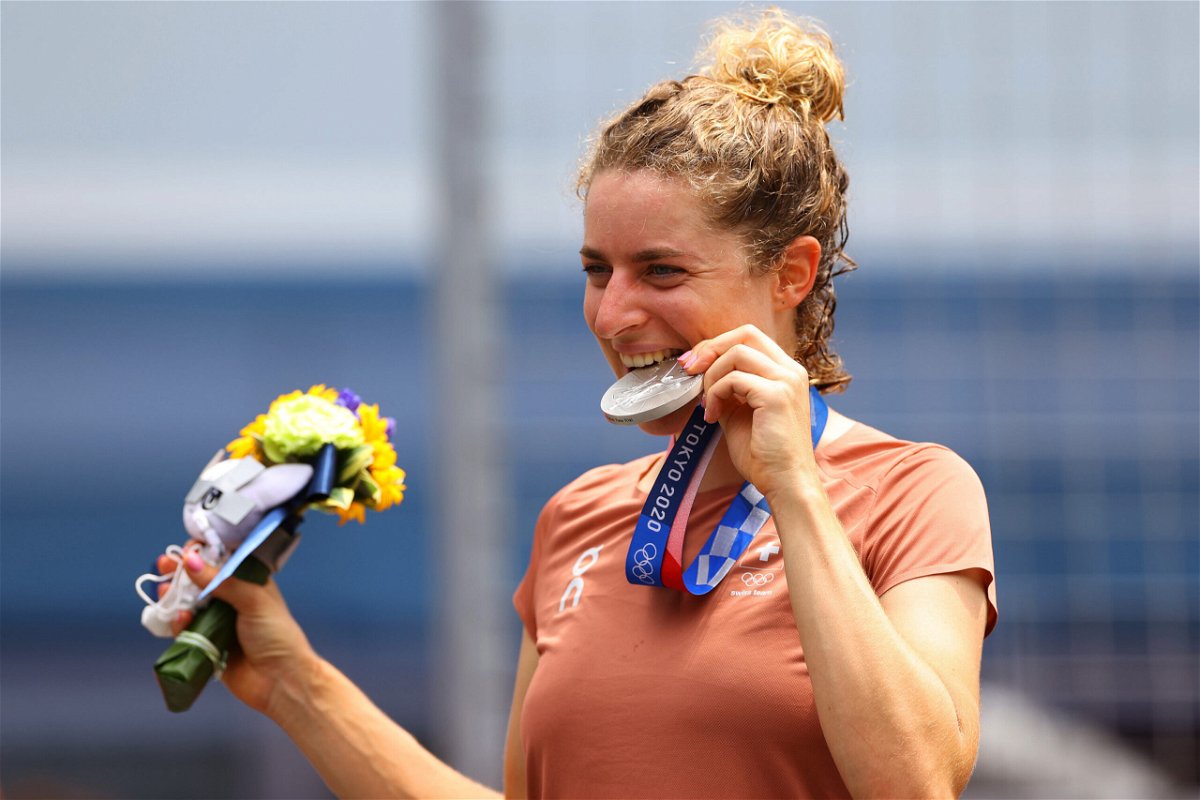 <i>Tim de Waele/Getty Images</i><br/>Swiss cyclist Marlen Reusser poses for a photograph and bites her silver medal after the women's individual time trial.