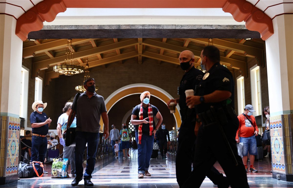 <i>Mario Tama/Getty Images</i><br/>People wear face coverings at Union Station in Los Angeles on July 19. Despite now having a powerful tool to help suppress the spread of coronavirus -- three very effective vaccines -- the nation is once again seeing rising cases