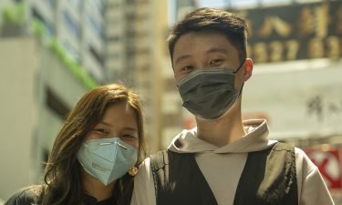 Eleanor Liao and Aaron Leung go for a walk in Hong Kong's Mong Kok neighborhood.