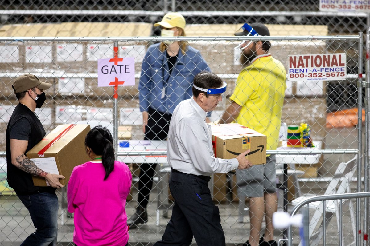 <i>Courtney Pedroza/Getty Images</i><br/>Former Secretary of State Ken Bennett (right) works to move ballots from the 2020 general election at Veterans Memorial Coliseum on May 1