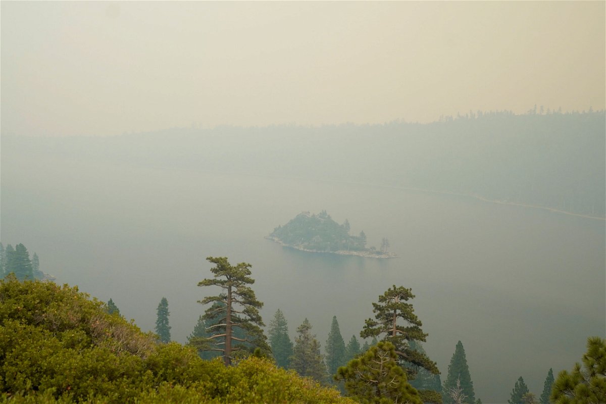 <i>Rich Pedroncelli/AP</i><br/>Lake Tahoe's Emerald Bay is shrouded in smoke from the Caldor Fire on Tuesday.