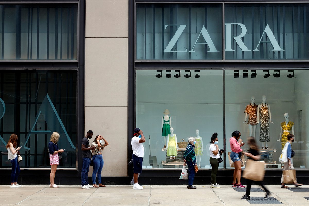 <i>Shafkat Anowar/AP</i><br/>The US economy grew slightly more in the second quarter. Shoppers are seen outside a Chicago downtown retail store