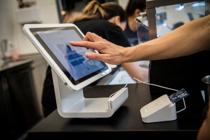 Afterpay logo displayed on a phone screen and Square logo displayed News  Photo - Getty Images