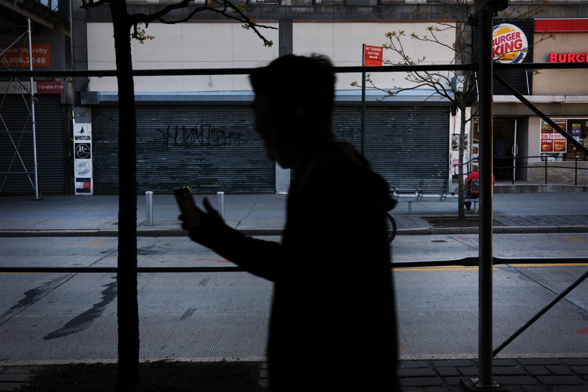 <i>Spencer Platt/Getty Images</i><br/>About 37.2 million people fell below the poverty line in 2020. People here walk through a shuttered business district in Brooklyn on May 12