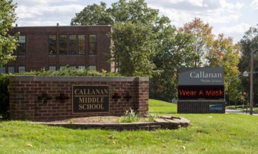Des Moines Public Schools officials will reinstate the district's mask mandate Wednesday. A sign reminds people to wear a mask outside Callanan Middle School in Des Moines