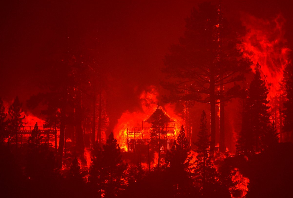 <i>Justin Sullivan/Getty Images</i><br/>The Caldor Fire burns homes near South Lake Tahoe