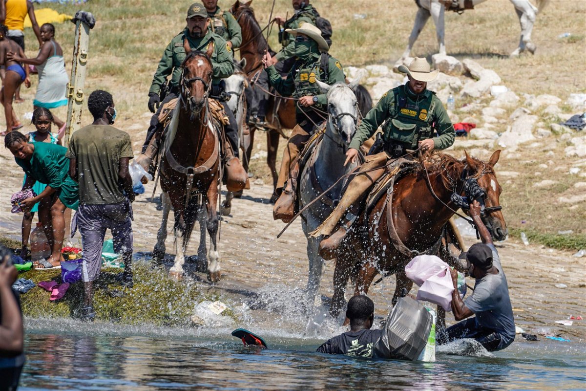 <i>Paul Ratje/AFP/Getty Images</i><br/>United States Border Patrol agents on horseback tries to stop Haitian migrants from entering an encampment on the banks of the Rio Grande near the Acuna Del Rio International Bridge in Del Rio