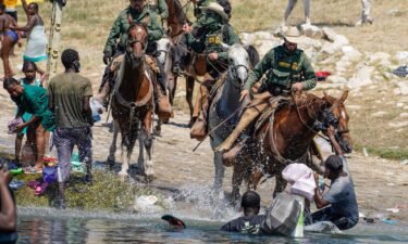 US Border Patrol agents on horseback try to stop Haitian migrants on Sunday from entering an encampment on the banks of the Rio Grande near the Acuna Del Rio International Bridge in Del Rio