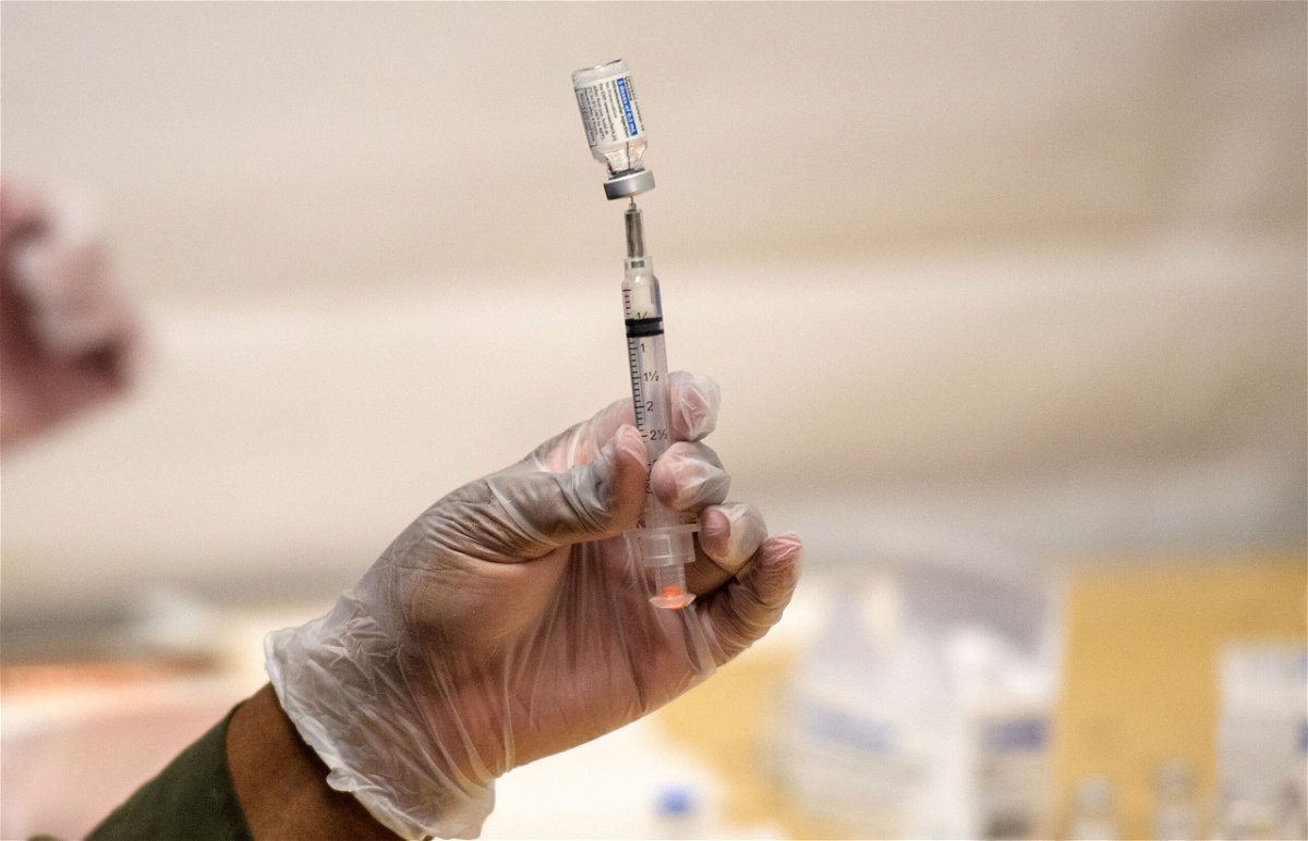 <i>Angela Weiss/AFP/Getty Images</i><br/>A healthcare worker prepares a syringe with a vial of the J&J/Janssen Covid-19 vaccine at a temporary vaccination site at Grand Central Terminal train station on May 12 in New York City.