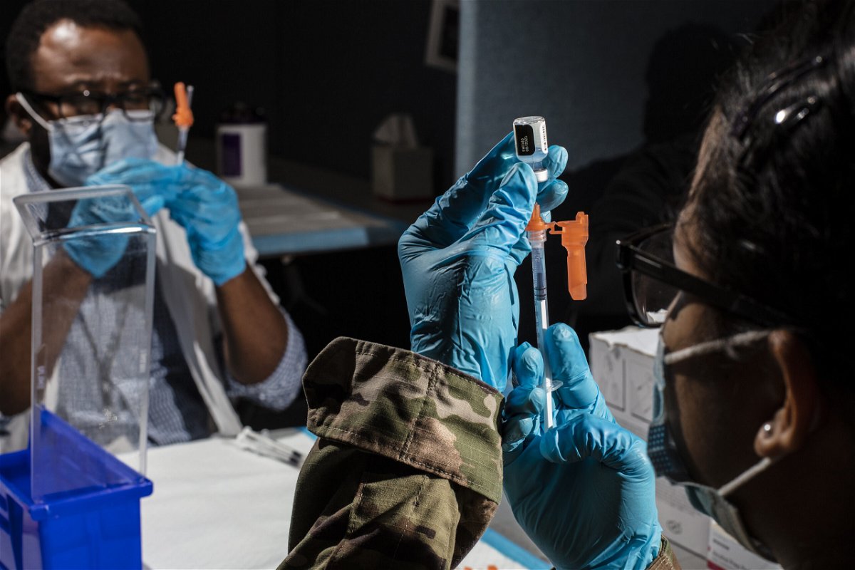 <i>Bryan Anselm/The New York Times/Redux</i><br/>A member of the United States military prepares a dose of the Pfizer-BioNTech Covid-19 vaccine in Newark