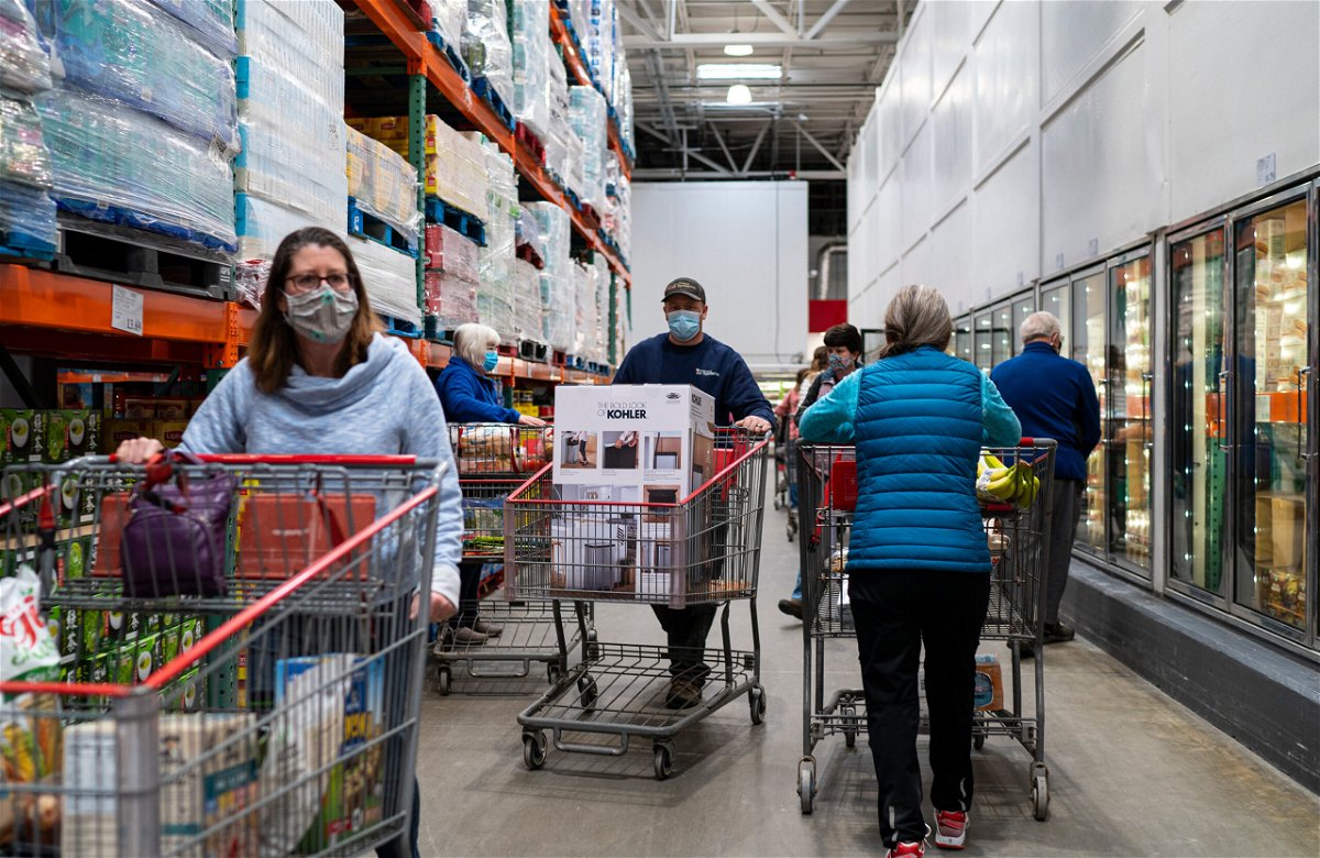 <i>Robert Nickelsberg/Getty Images</i><br/>Shoppers wearing masks search for items at a Costco Wholesale store on February 26 in Colchester