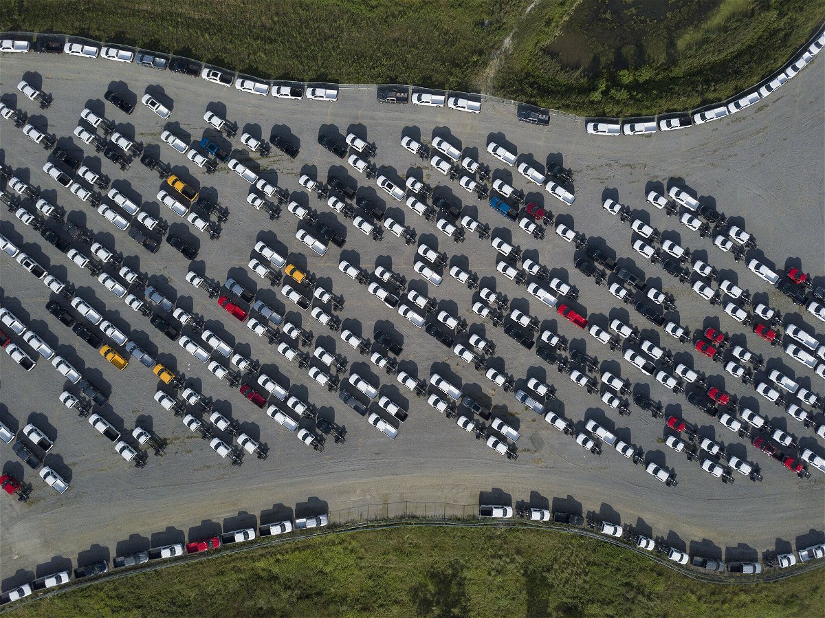 <i>Jeffrey Scott Dean/Bloomberg/Getty Images</i><br/>America's factories have struggled with shortages of materials and qualified workers. New Ford F-Series pickup trucks are shown here stored in a lot during a semiconductor shortage at Kentucky Speedway in Sparta