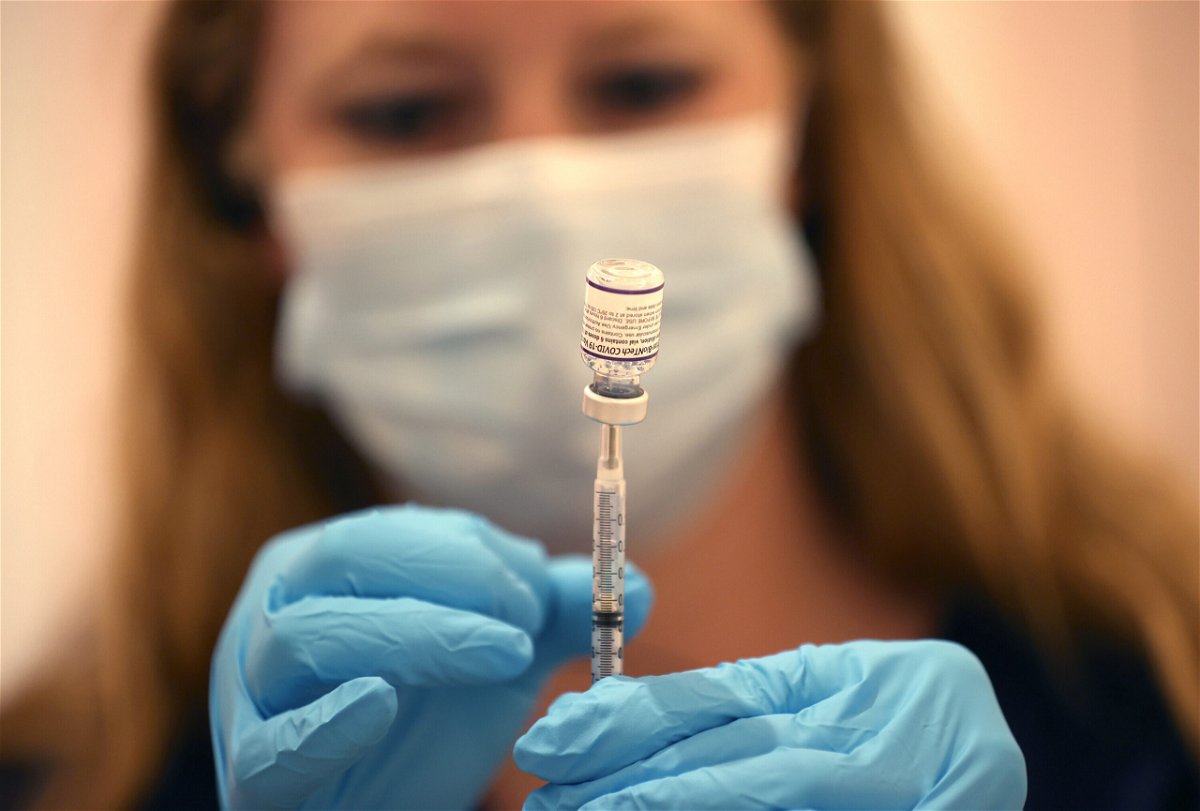 <i>Justin Sullivan/Getty Images</i><br/>Safeway pharmacist Ashley McGee fills a syringe with the Pfizer COVID-19 booster vaccination at a vaccination booster shot clinic on October 1 in San Rafael