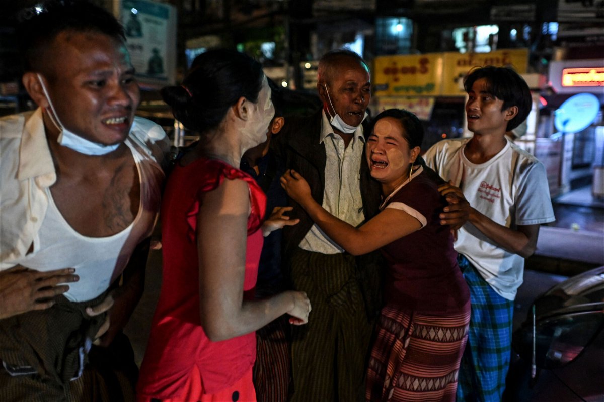 <i>AFP/Getty Images</i><br/>A man is reunited with his family members following his release outside Insein Prison in Yangon