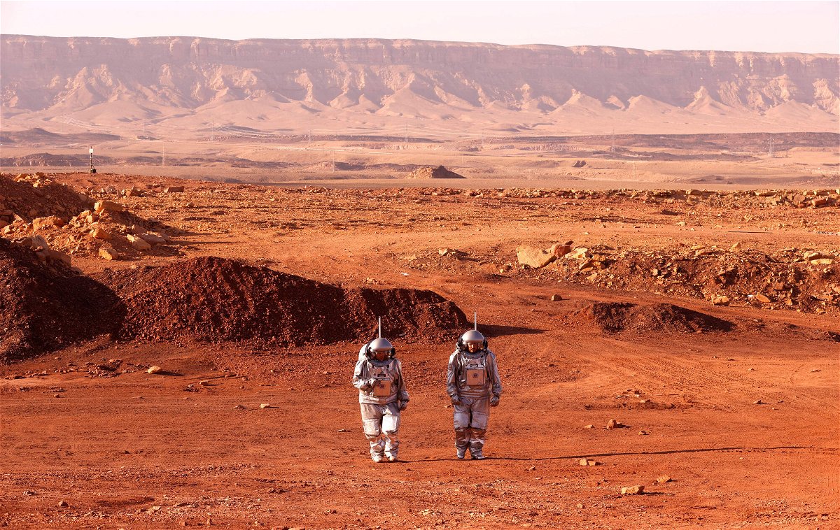 <i>Jack Guez/AFP/Getty Images</i><br/>A couple of astronauts from a team from Europe and Israel walk in spacesuits during a training mission for planet Mars at a site that simulates an off-site station at the Ramon Crater in Mitzpe Ramon in Israel's southern Negev desert on October 10.