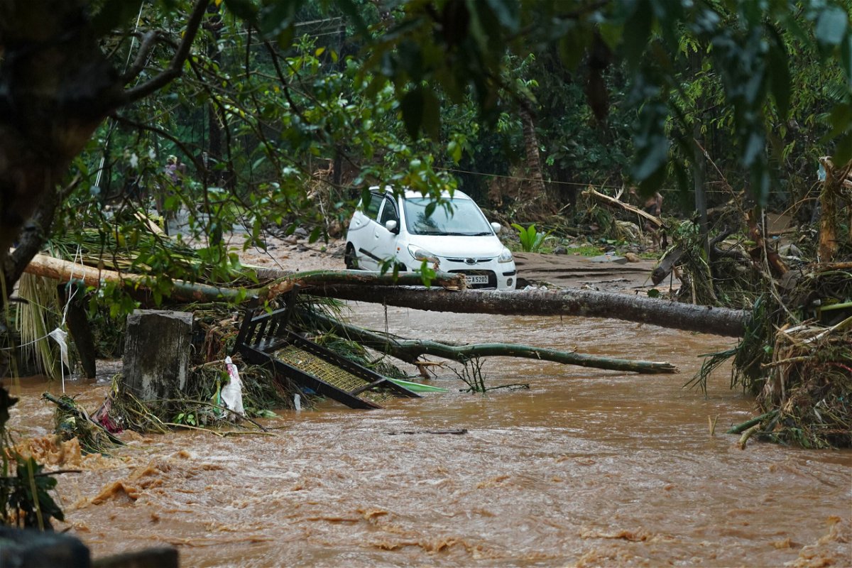 <i>Appu S. Narayanan/AFP/Getty Images</i><br/>A car is stuck in muddy water after torrential rain in Kerala state on October 16.