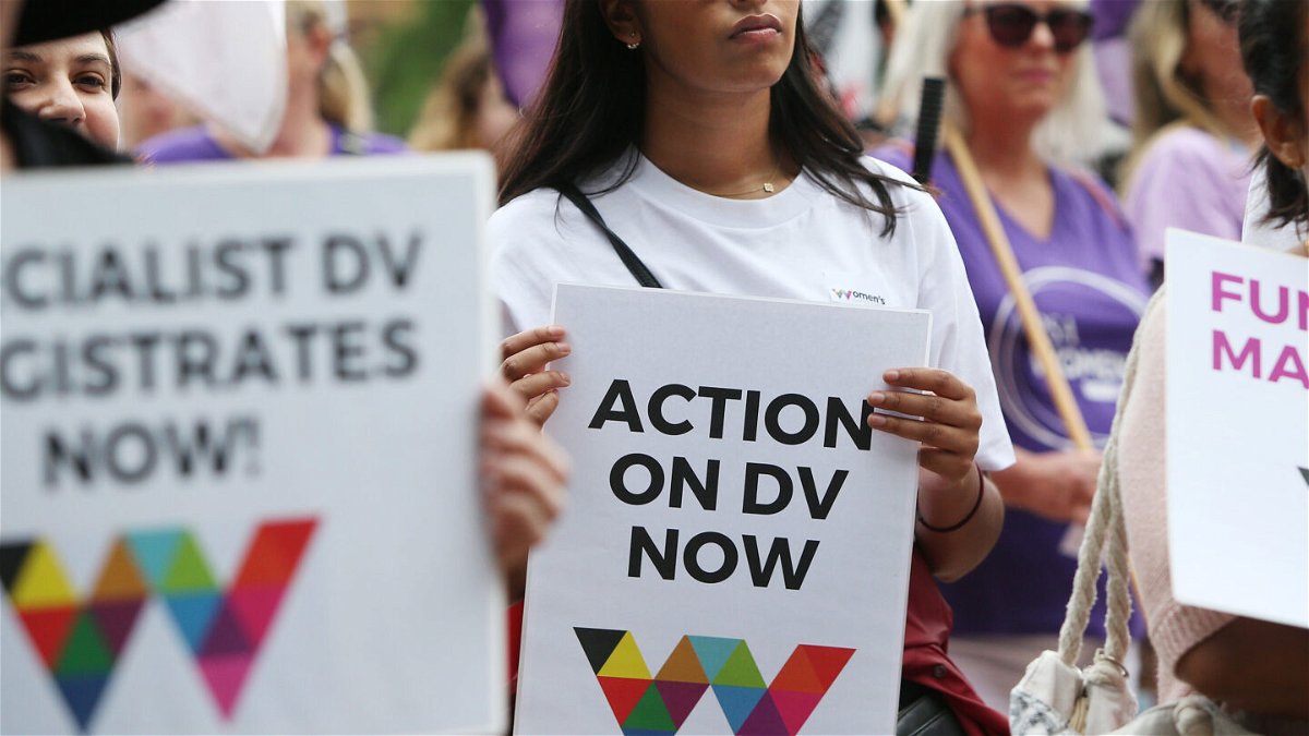 <i>Lisa Maree Williams/Getty Images</i><br/>Women hold signs urging action against domestic violence during the 2020 International Women's Day march in Sydney.