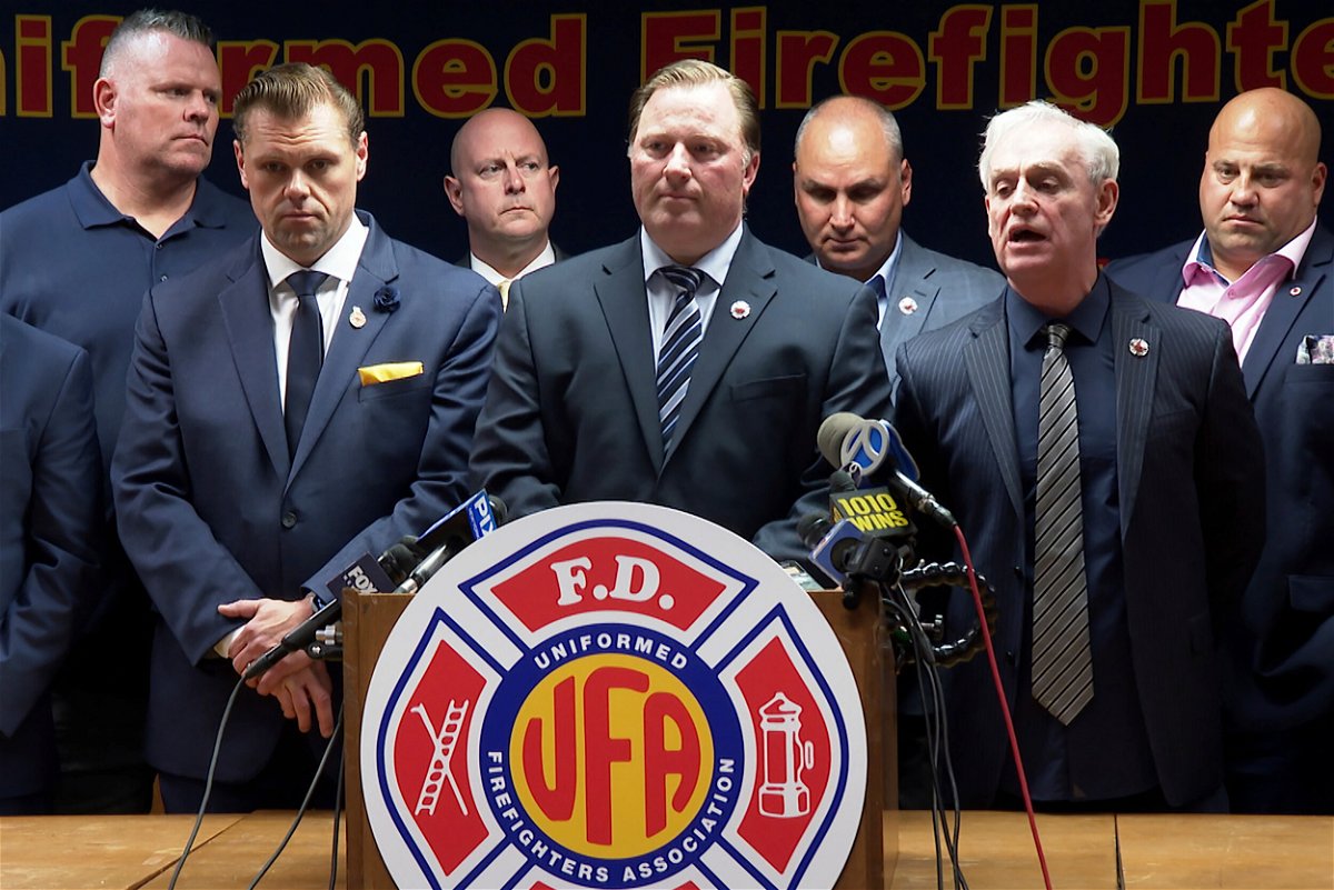 <i>Ted Shaffrey/AP/FILE</i><br/>New York fire and police departments are scrambling to cover staff shortages when vaccine mandate takes effect this week. Pictured is the Uniformed Firefighters Association during a news conference in New York City on Wednesday.