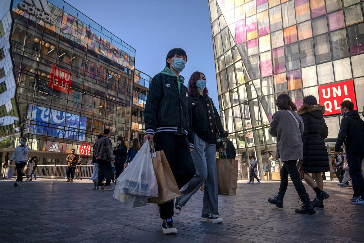 <i>Andrea Verdelli/Getty Images</i><br/>People walk in Sanlitun shopping area on October 16