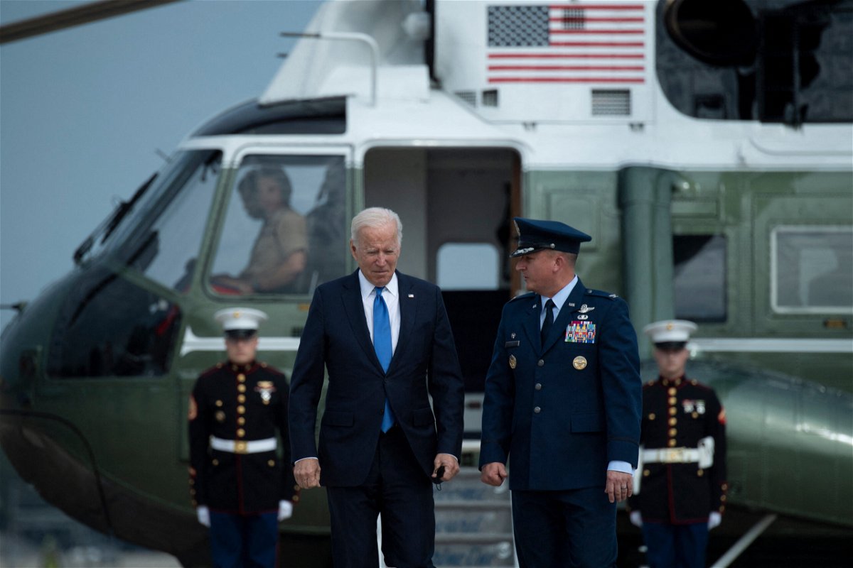 <i>BRENDAN SMIALOWSKI/AFP/Getty Images</i><br/>US President Joe Biden is greeted by Col. Matthew Jones (R)