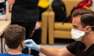 A nurse administers a test to an unidentified student during a COVID-19 testing day at Brandeis Elementary School on August 17 in Louisville