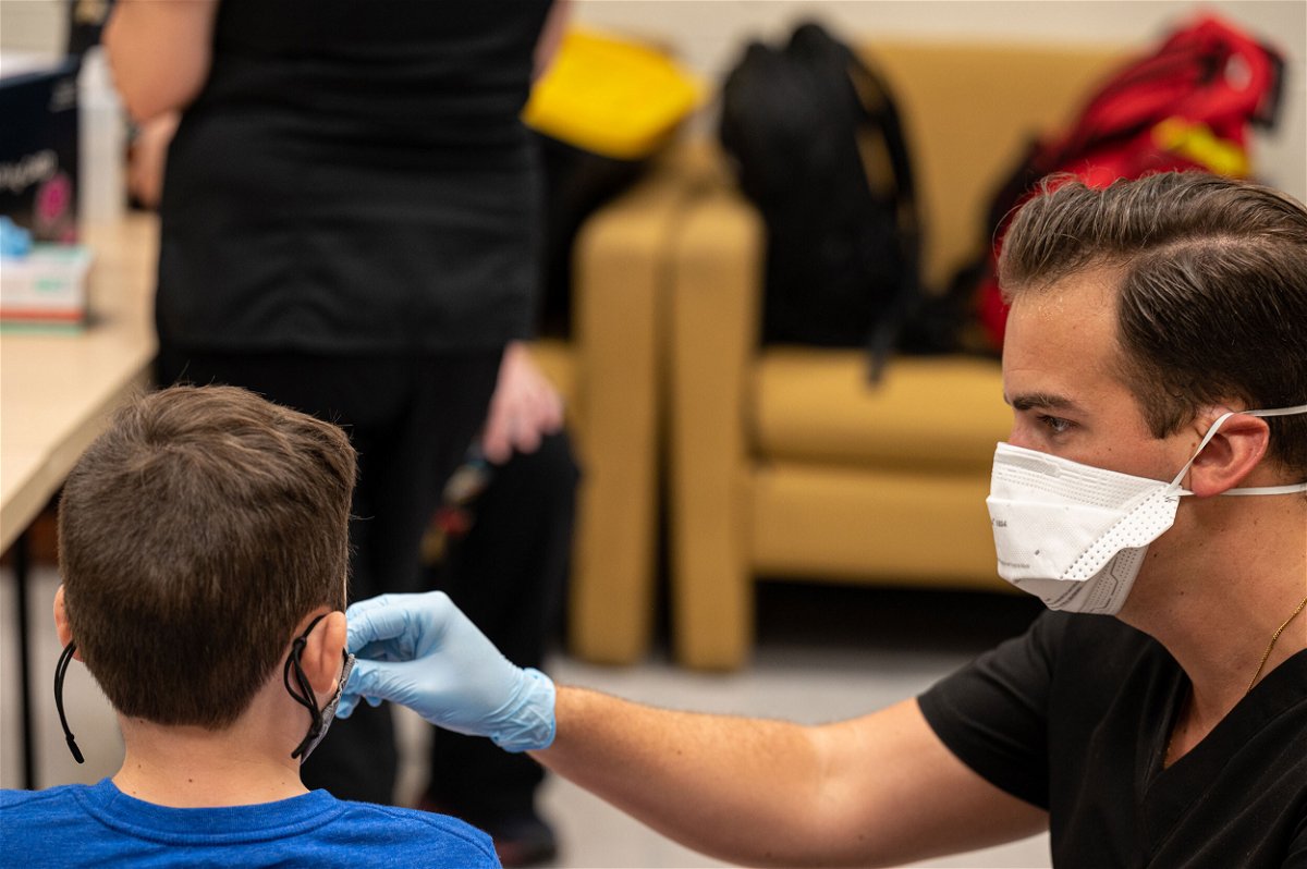 <i>Jon Cherry/Getty Images</i><br/>A nurse administers a test to an unidentified student during a COVID-19 testing day at Brandeis Elementary School on August 17 in Louisville