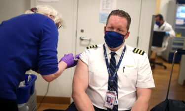 United Airlines pilot Steve Lindland receives a Covid-19 vaccine at O'Hare International Airport in March 2021.