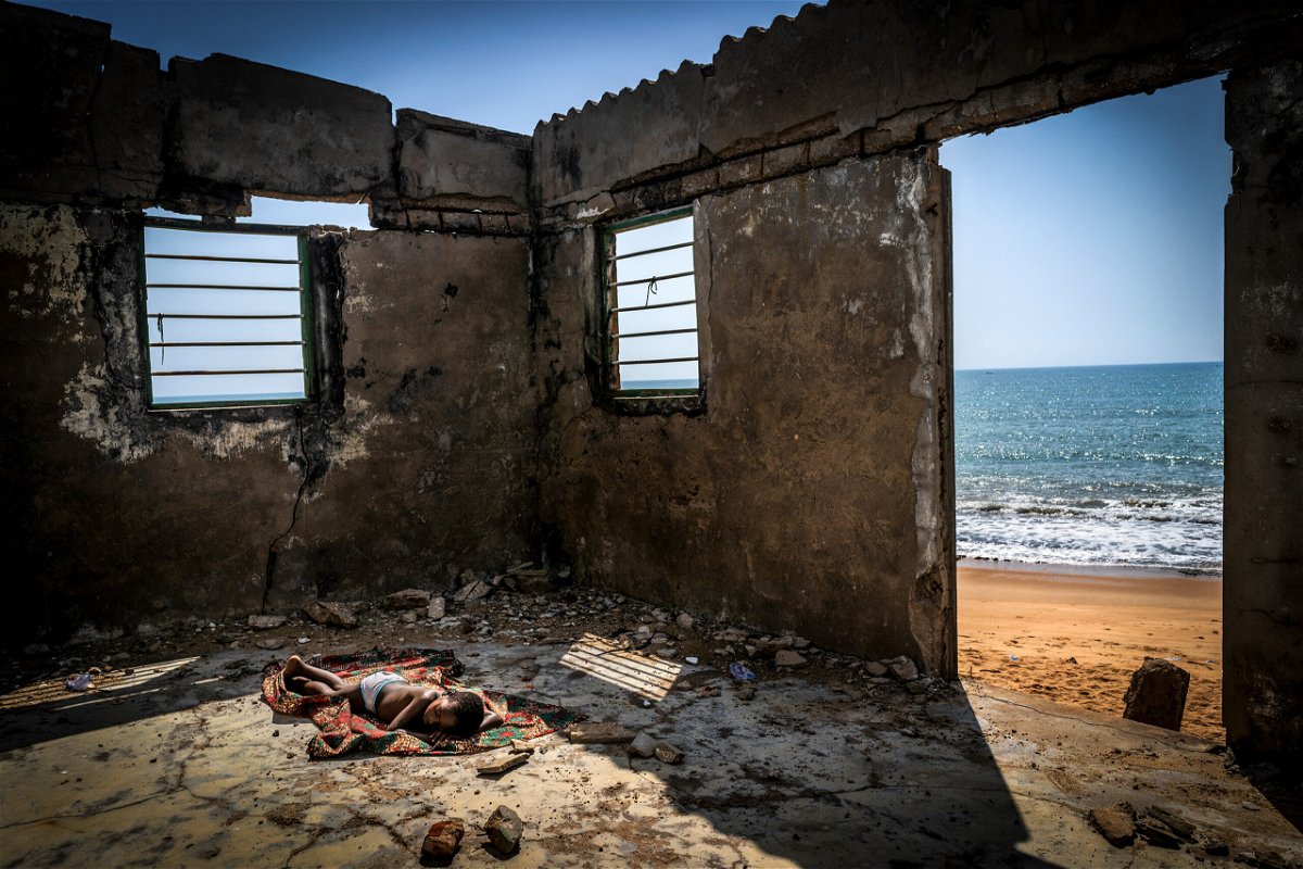 <i>Antonio Aragon Renuncio/Environmental Photographer of the Year 2021</i><br/>A child sleeps inside his house destroyed by coastal erosion on Afiadenyigba beach. Sea-levels in West-African countries continue to rise and thousands of people have been forced to leave their homes. This haunting image
