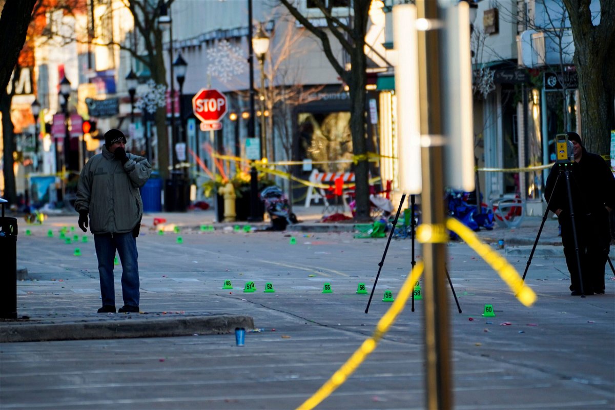 <i>Cheney Orr/Reuters</i><br/>Police officers document marked evidence on Main Street the morning after a vehicle plowed through a holiday parade in Waukesha on Sunday.