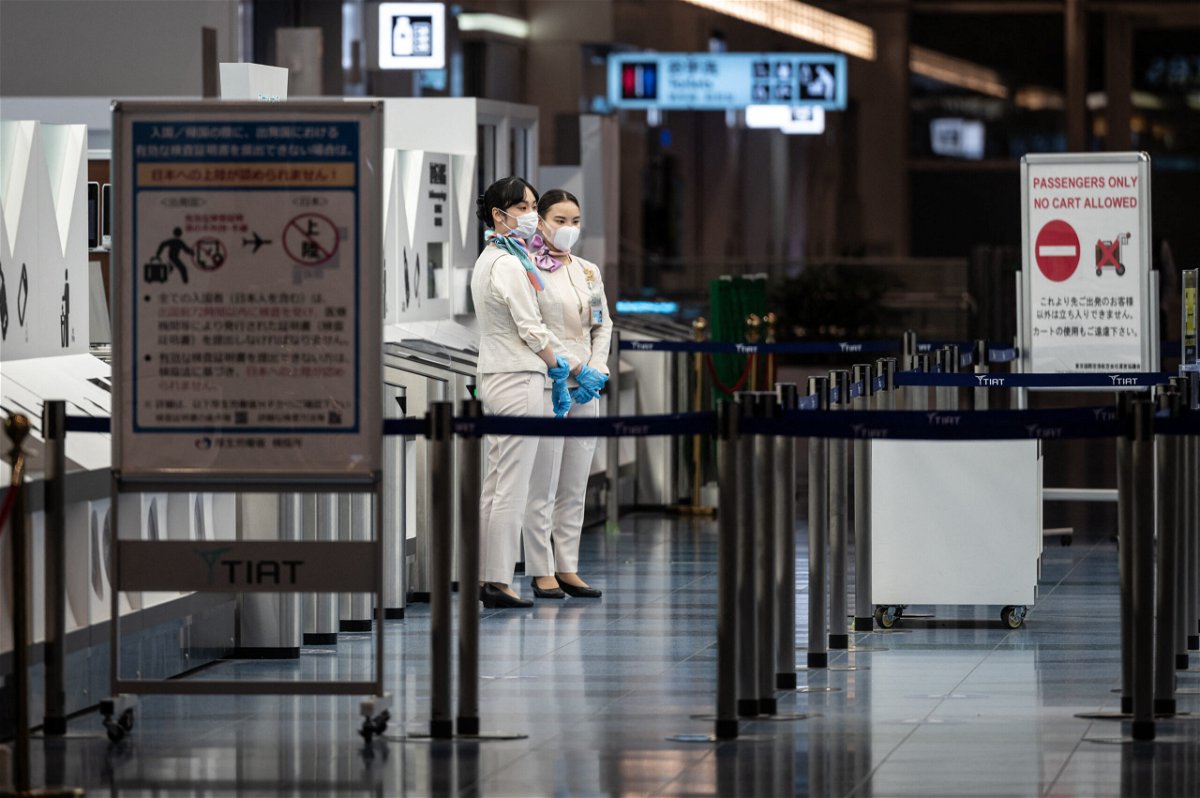 <i>PHILIP FONG/AFP/Getty Images</i><br/>Staff members stand at the departure gate of Tokyo's Haneda international airport on November 29