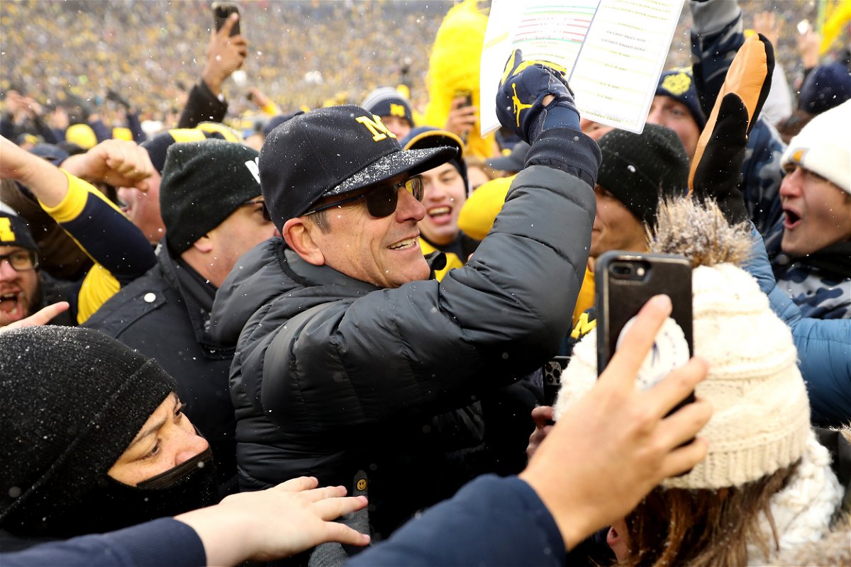 <i>Mike Mulholland/Getty Images/FILE</i><br/>Michigan Wolverines Head Coach Jim Harbaugh celebrated with fans after defeating Ohio State.