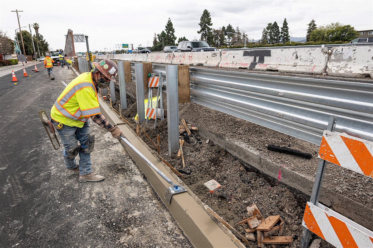 <i>David Paul Morris/Bloomberg/Getty Images</i><br/>A contractor works on a road under repair along Highway 101 in San Mateo