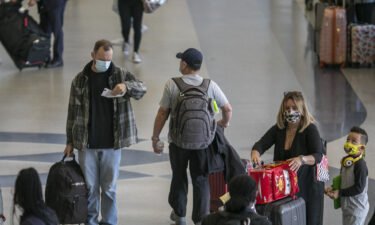 Holiday travelers pass through Los Angeles International Airport in November of 2020. Air travel is expected to be up 80% for Thanksgiving this year.