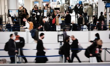 Travelers arrive for flights at Newark Liberty International Airport on November 30 in Newark