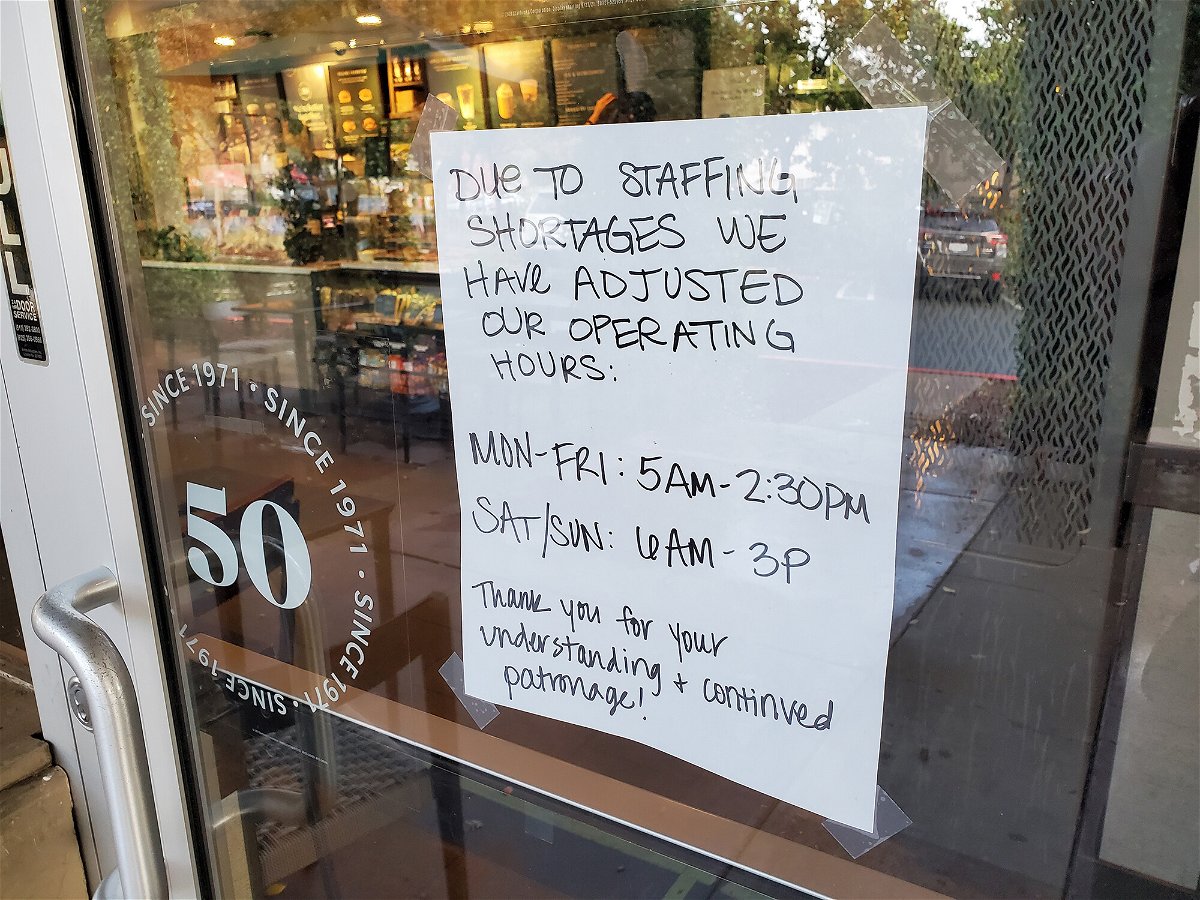 <i>Smith Collection/Gado/Getty Images</i><br/>A handwritten sign explains reduced hours at a Starbucks Cofee cafe in Lafayette