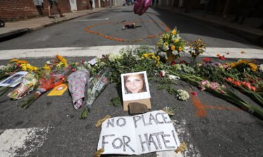 Flowers surround a photo of 32-year-old Heather Heyer